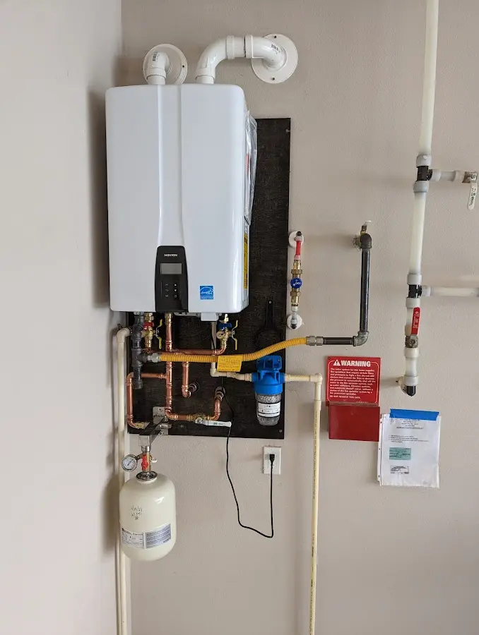 Professional plumber installing copper piping in a Alvin home